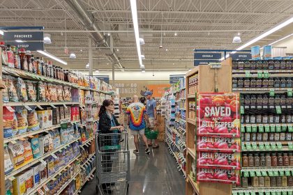 Shelves of packaged foods in a supermarket aisle.