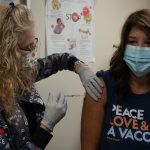 Healthcare worker preparing a measles MMR vaccination, illustrating guidance as US measles cases rise