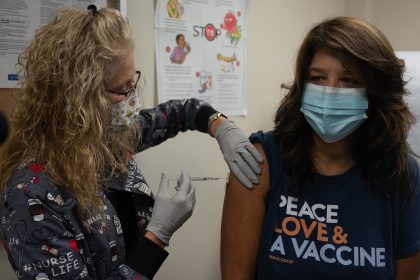 Healthcare worker preparing a measles MMR vaccination, illustrating guidance as US measles cases rise